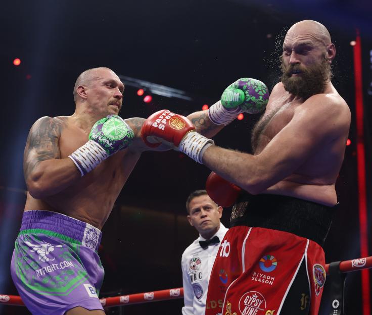 Oleksandr Usyk punches Tyson Fury during their boxing match.