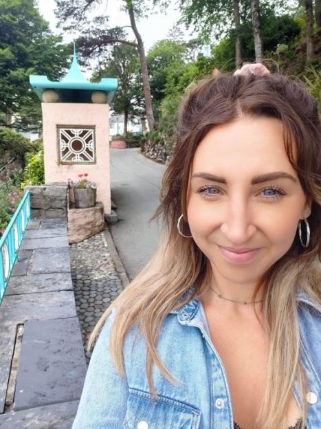 Charlotte Dodd posing for a selfie outdoors.