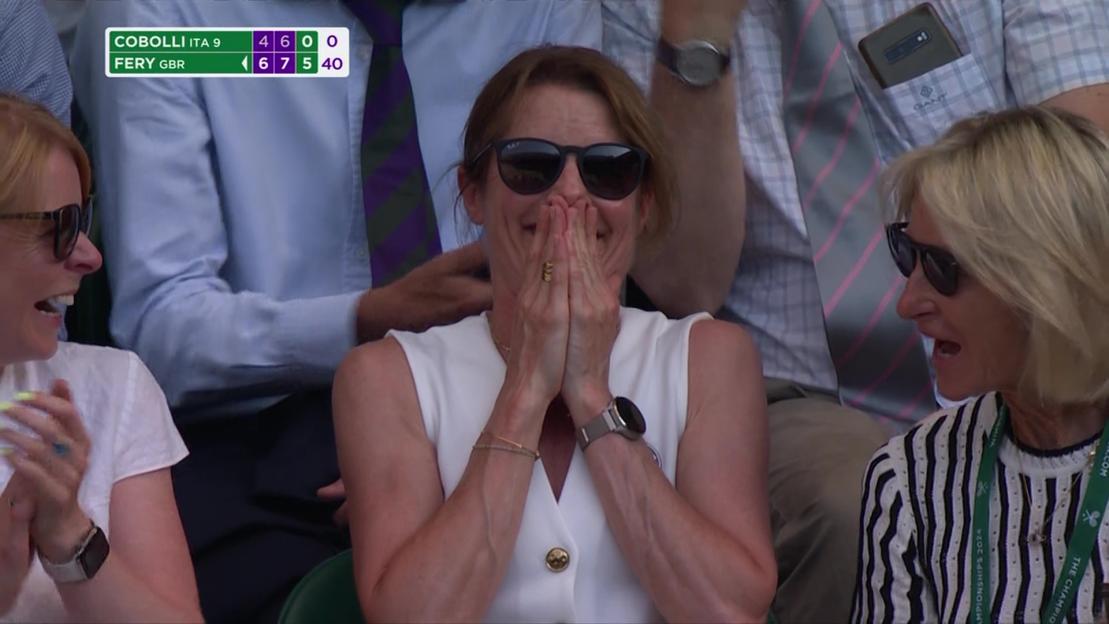 Arthur Fery's mum with hands over her mouth and sunglasses on, watching him win at Wimbledon quarter-finals.