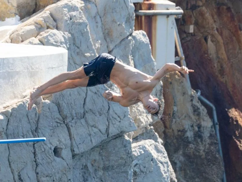 Beau Minniear dives into the Mediterranean from the swimming platform at Hotel du Cap-Eden-Roc in the South of France.