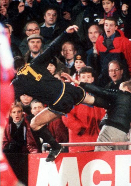 Eric Cantona airborne as he performs a "kung-fu" kick on a fan in the stands.