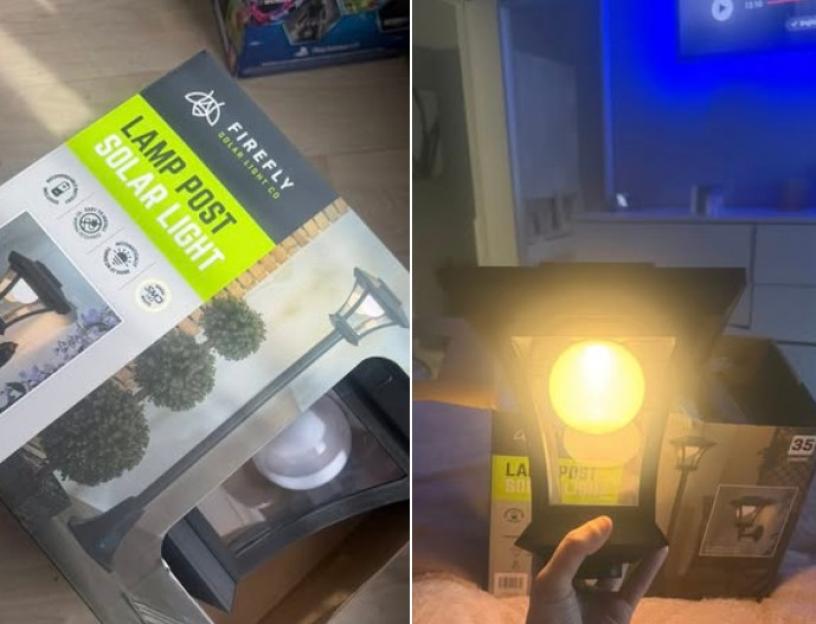 A person holding a glowing lamp post solar light with its packaging next to it.