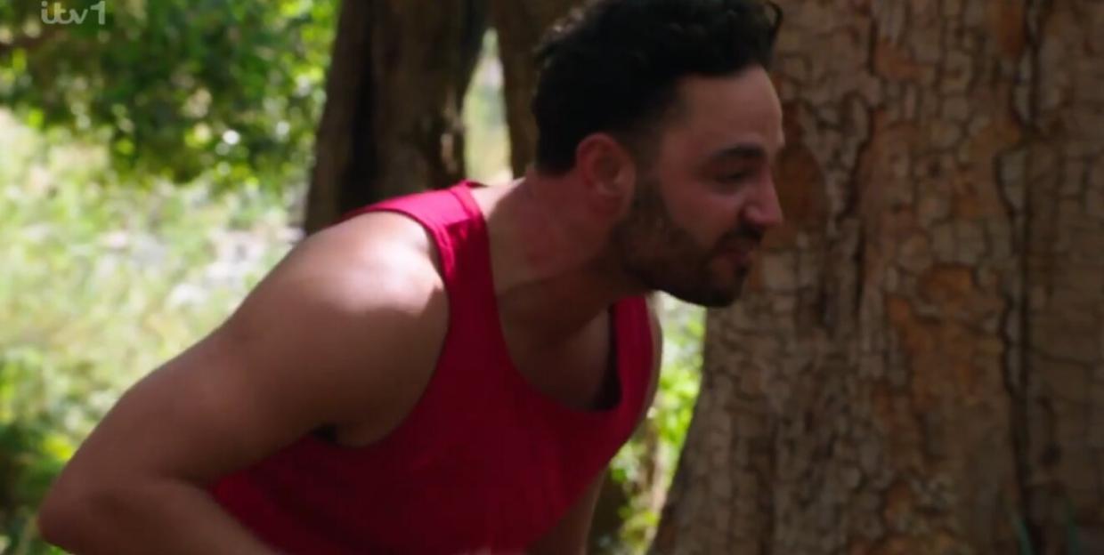 Adam Thomas in a red tank top.