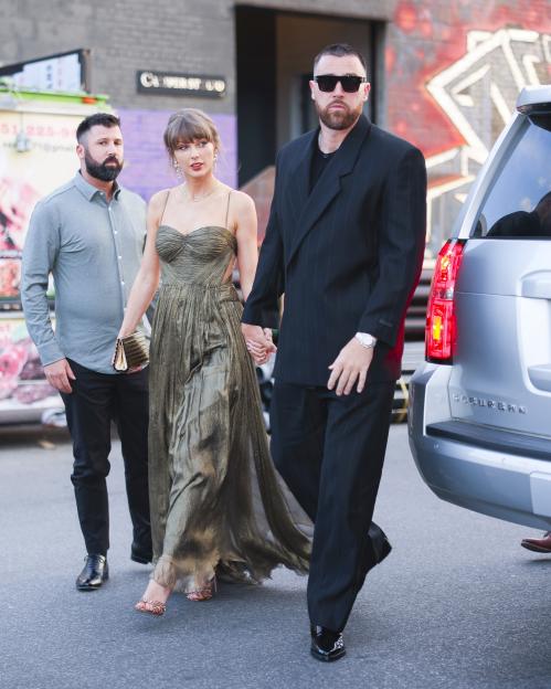 Taylor Swift and Travis Kelce holding hands while walking with a bodyguard in New York City.