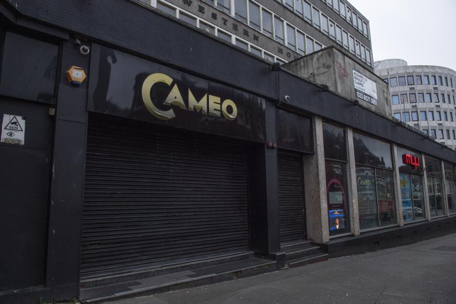 The exterior of the Cameo nightclub in Bournemouth, with its entrance closed by a black roller shutter.