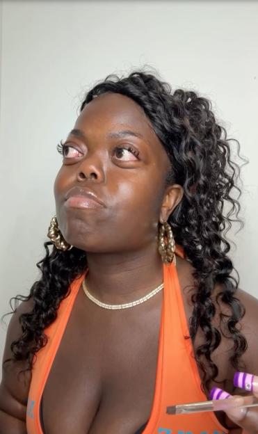Fats Timbo, looking up and to the left with tears in her eyes.