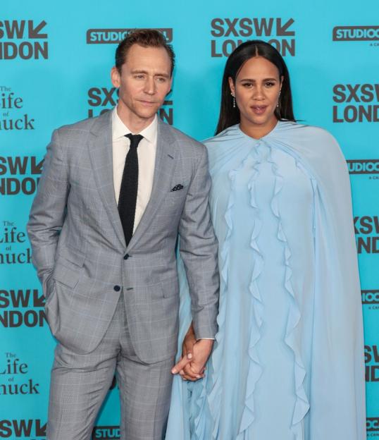 Tom Hiddleston and Zawe Ashton holding hands at "The Life of Chuck" UK premiere.