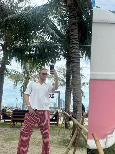 Freddie Bentley taking a selfie in a mirror outdoors.