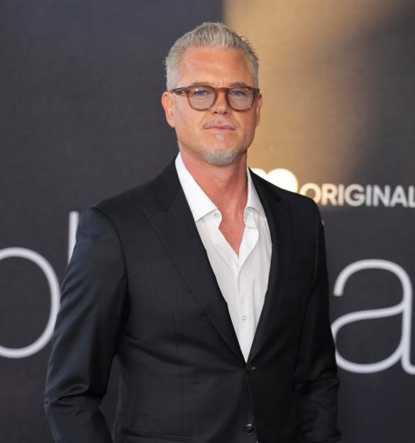 Eric Dane in a black suit and white shirt.