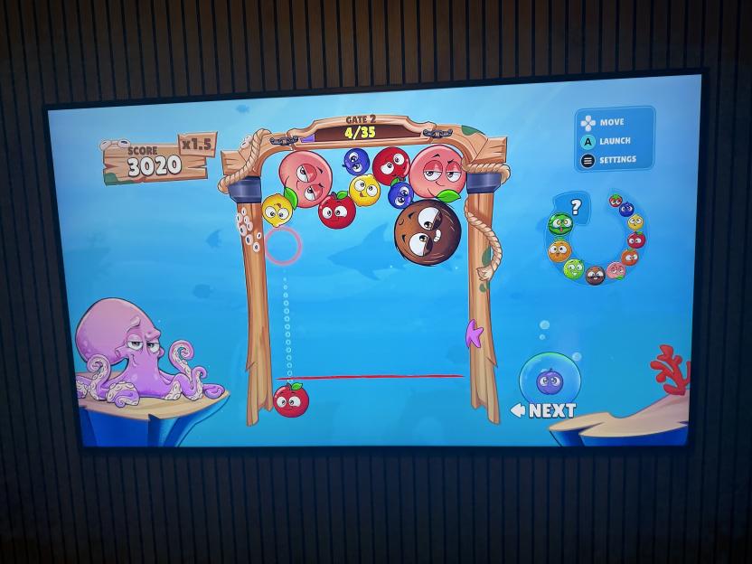 Illustration of a Fruit Connect 2 video game being played on a screen.