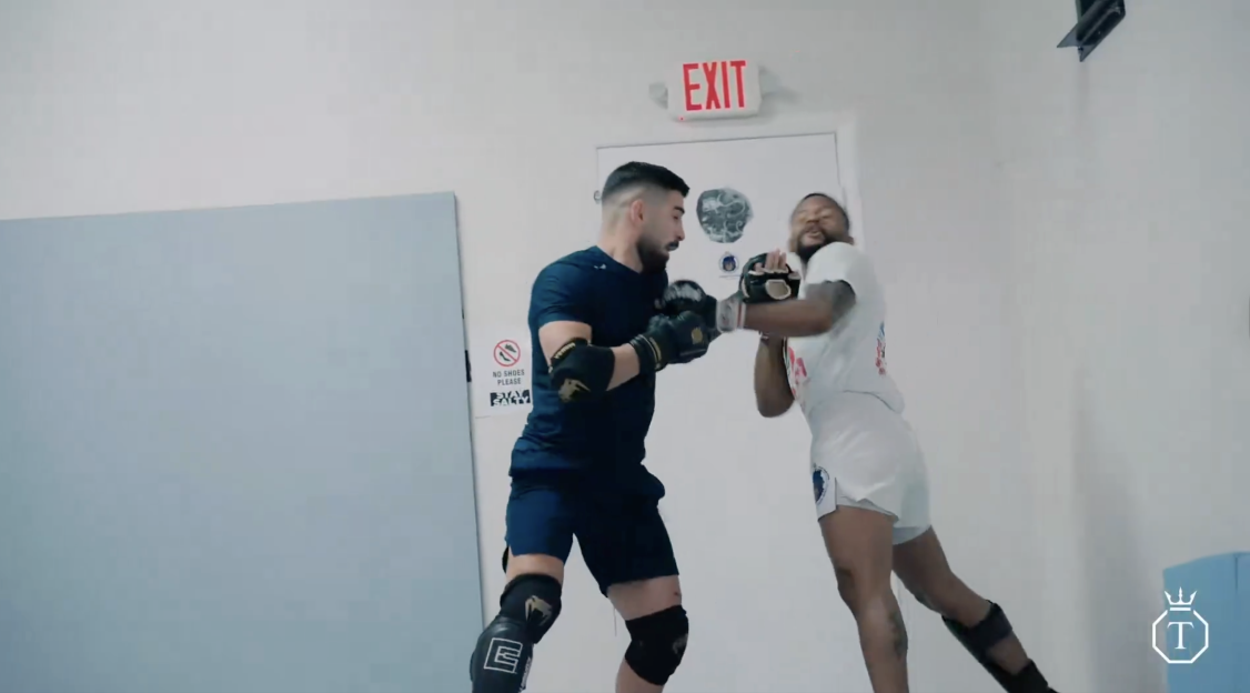 Two men boxing in a gym.