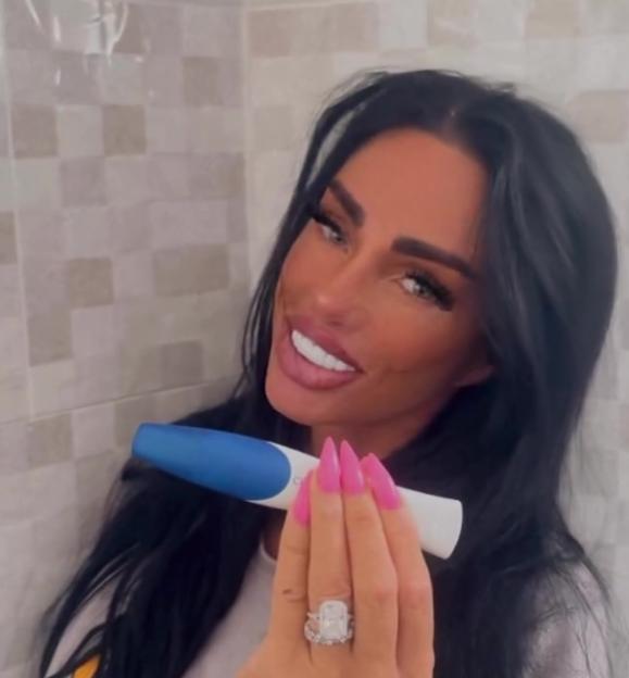 Katie Price holding a pregnancy test.