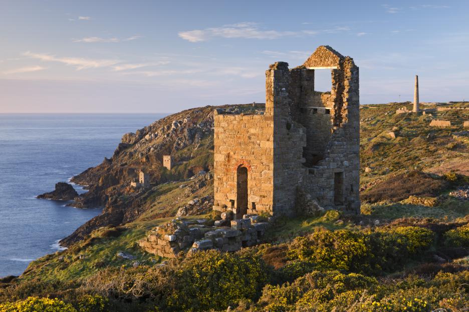a stone tower sits on a cliff overlooking the ocean