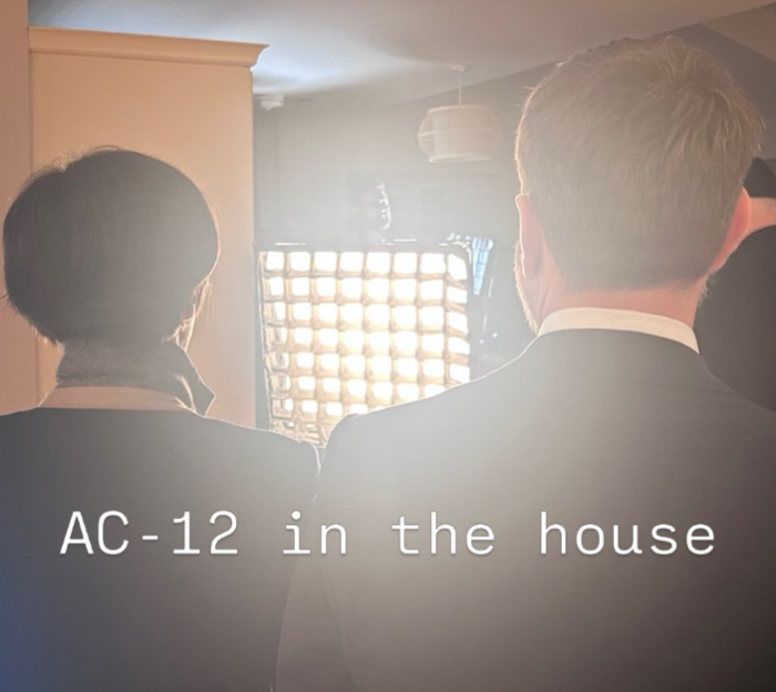 Two people from behind facing a bright light source.