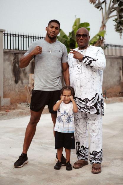 Anthony Joshua poses with his father and son.