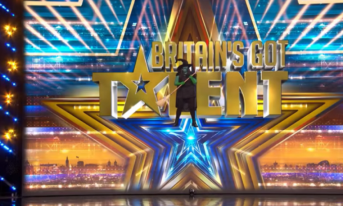 A person dressed as the Wicked Witch of the West from The Wizard of Oz stands on the Britain's Got Talent stage.