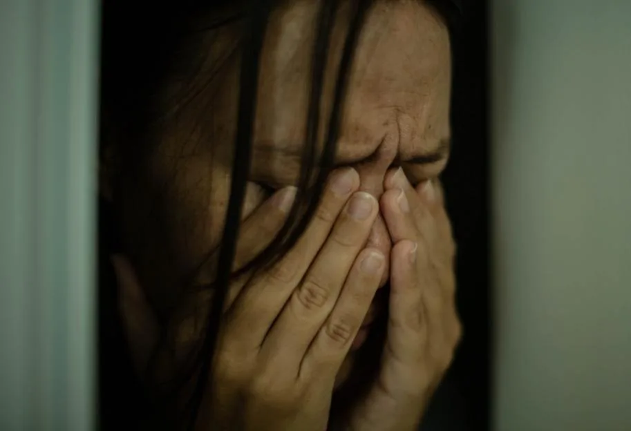 Sad woman crying alone. Victim of domestic abuse.