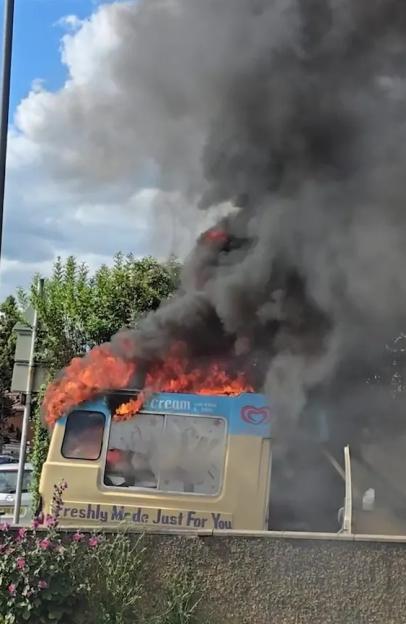 'Stunning Scene: Ice Cream Van Erupts in Flames, Billowing Smoke Fills the Sky!'