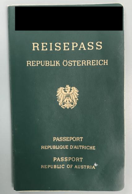 A fake Austrian passport with a blacked-out top section.