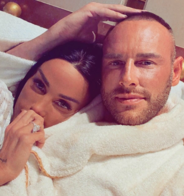 Katie Price and her new millionaire husband lying together in bathrobes.