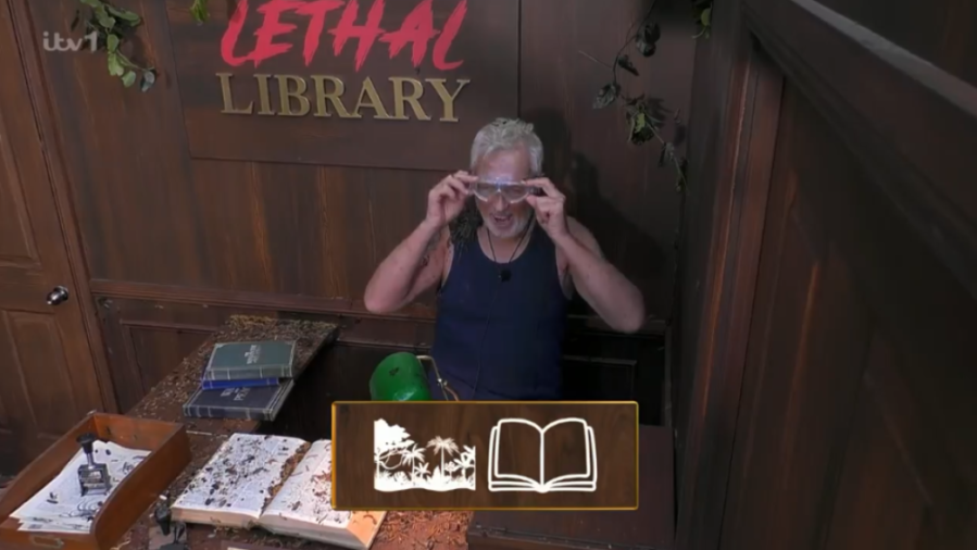 A man wearing safety glasses in a room labeled "Lethal Library," with a graphic showing jungle scenery and an open book.