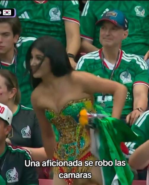 Screenshot of an Instagram post showing a woman in a green corset and skirt at a soccer game.