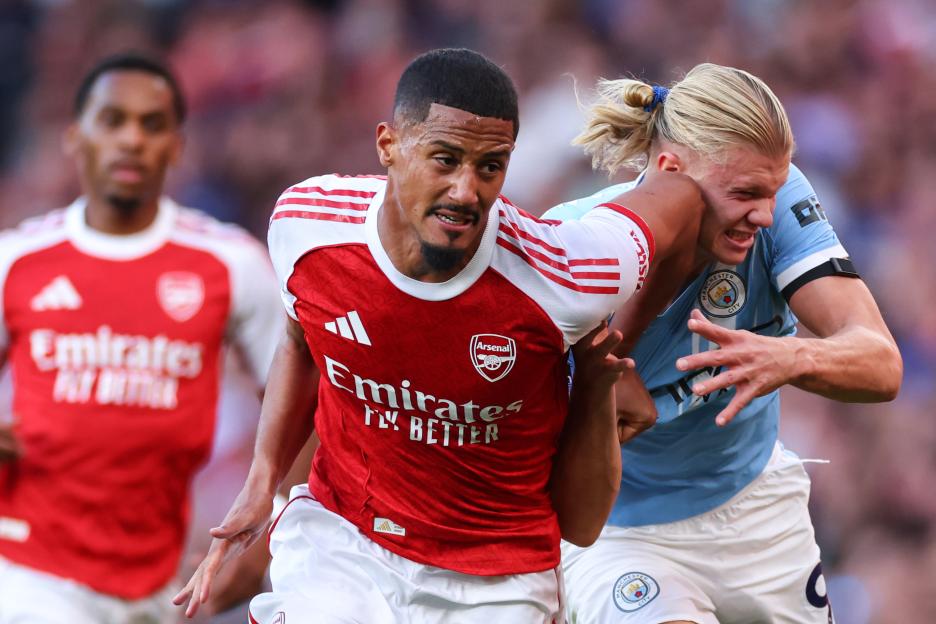 William Saliba of Arsenal in action with Erling Haaland of Manchester City.