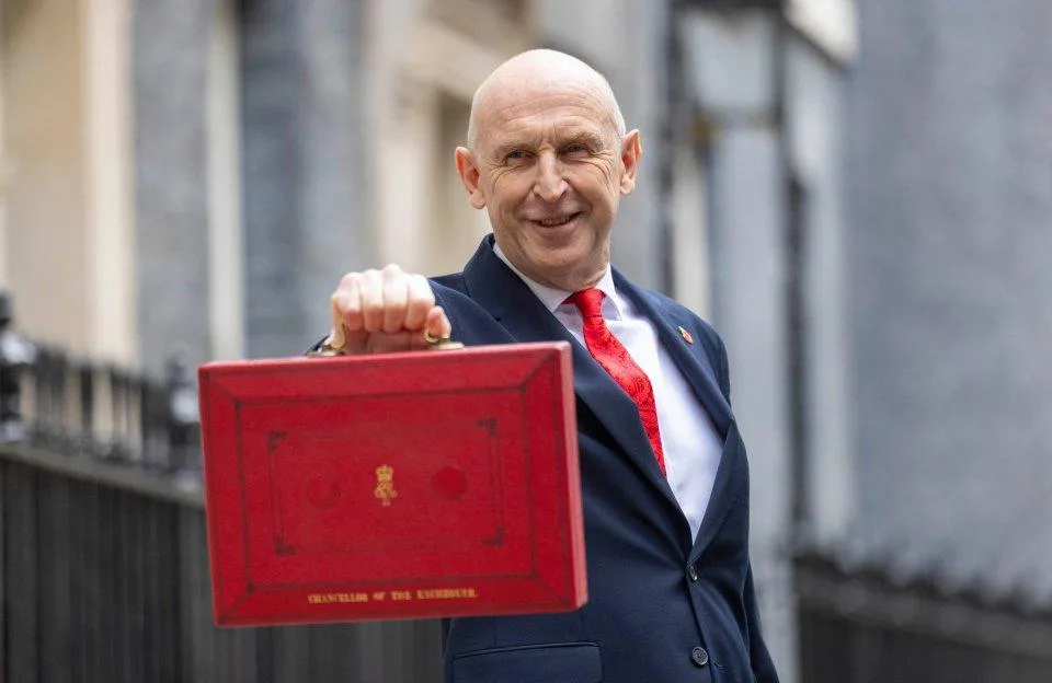 Chancellor John Healey holds up the red Budget box outside Number 11 Downing Street.