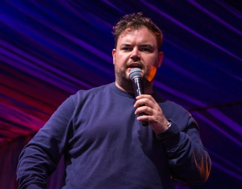 Comedian Lloyd Griffith hosting the comedy stage at Latitude Festival.