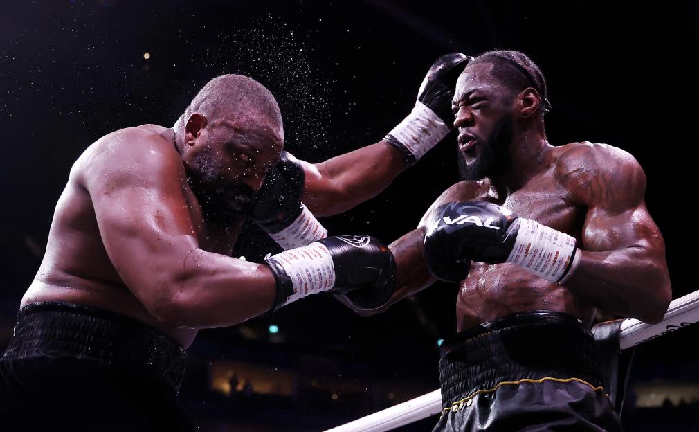 Deontay Wilder punches Derek Chisora during their heavyweight fight.