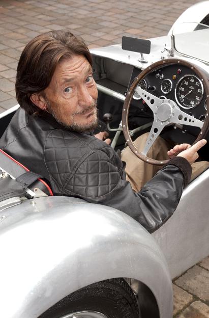 Chris Rea driving his Lotus 6 sports car.