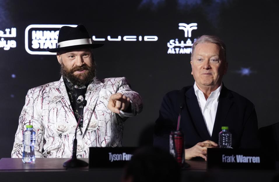 Boxer Tyson Fury and boxing promoter Frank Warren at a press conference.