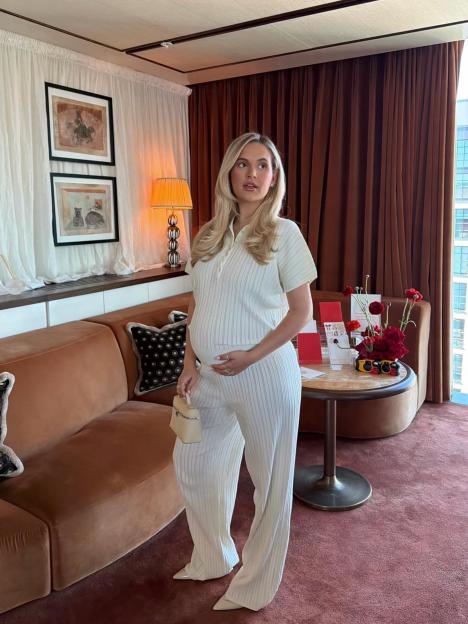 Molly-Mae Hague, pregnant, poses in a cream ribbed outfit.
