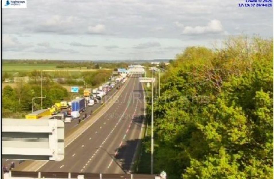 Overhead view of a highway with heavy traffic on the left lanes and clear lanes on the right.