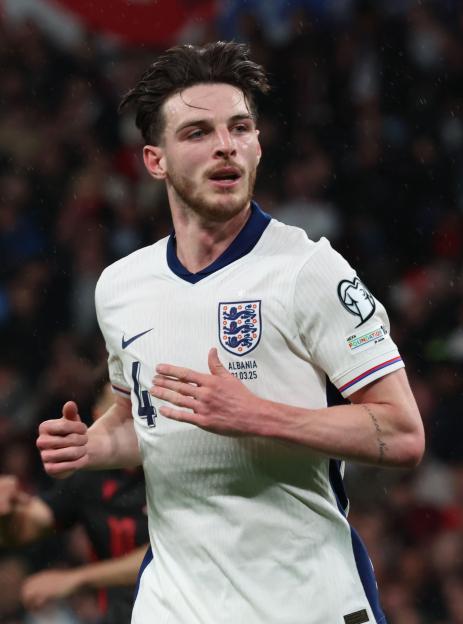 Declan Rice of England in a white and blue uniform on the field during a World Cup Qualifier match against Albania.