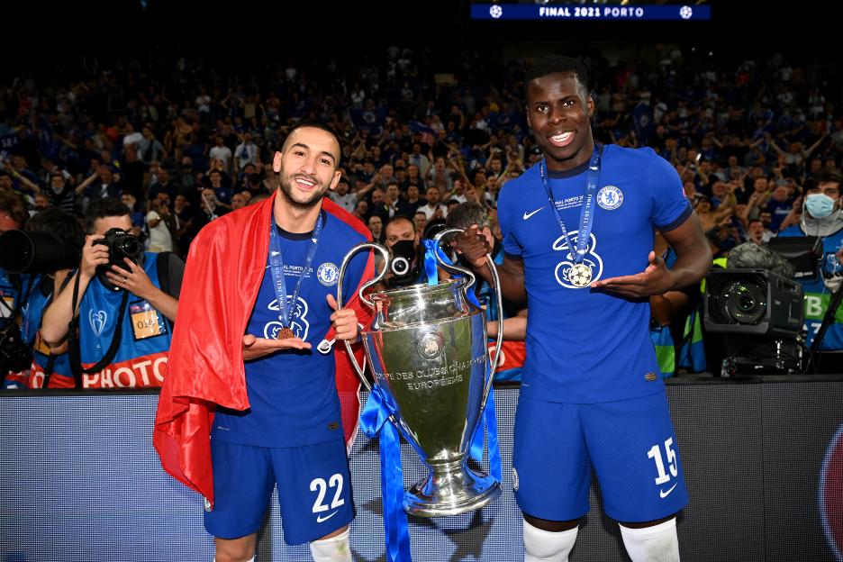 Hakim Ziyech and Kurt Zouma holding the UEFA Champions League trophy.