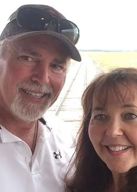Kirk Schwabe and a woman, both smiling, with a railroad track behind them.