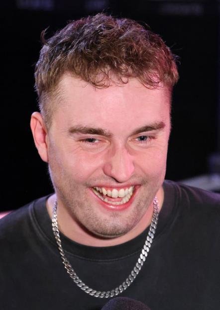 Sam Fender smiles widely backstage at the Mercury Music Awards 2025.