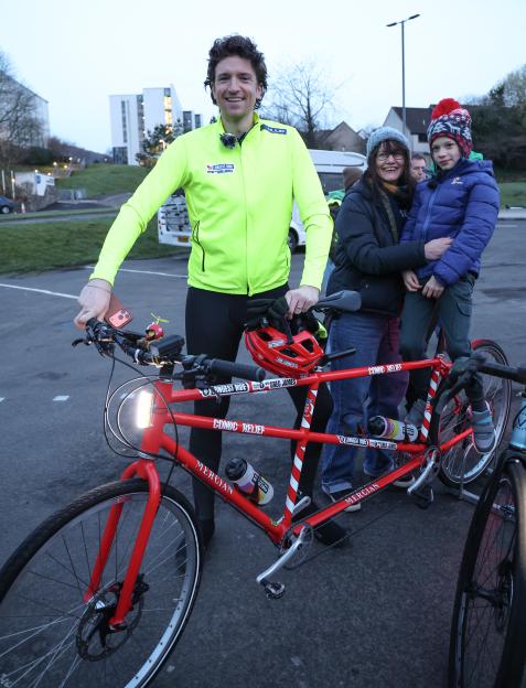 Greg James stands with well-wishers and a red tandem bike for the Comic Relief Longest Ride challenge.