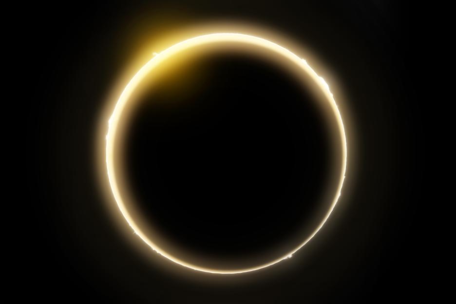 Solar eclipse showing the sun's corona and solar flares.