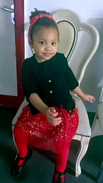 Lesma-Rose Wibier, 4, sitting in a white chair.