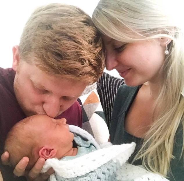 Sam Aston and wife Briony with their newborn baby.