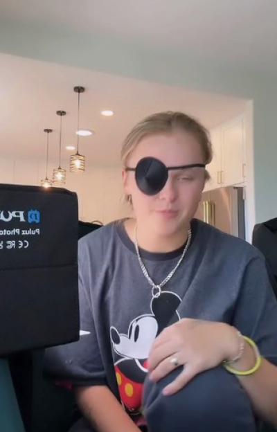 JoJo Siwa wearing an eye patch and a Mickey Mouse t-shirt.