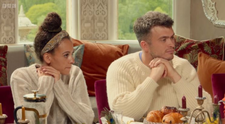 Reece and another contestant at the breakfast table in "The Traitors".