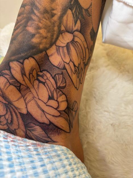 Katie Price's new thigh tattoo featuring a large floral design.