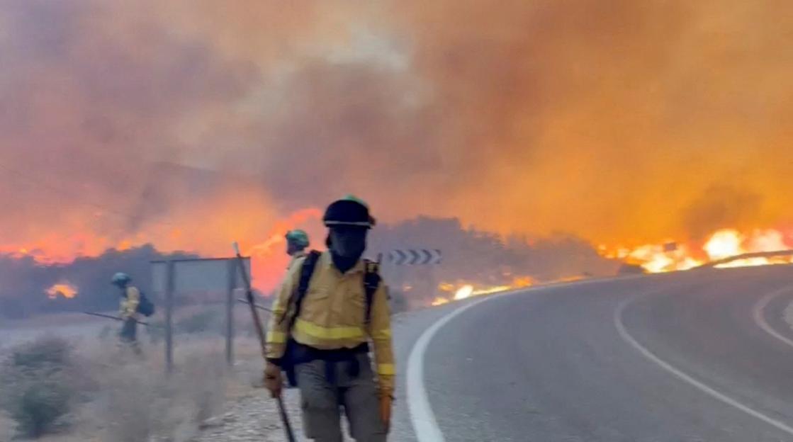 Emergency personnel work during a wildfire in Almeria