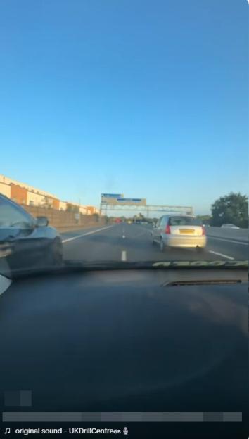 Dashboard view of cars driving on a highway.