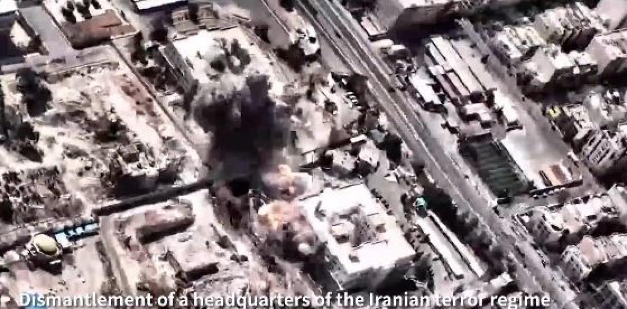 Aerial view of an explosion and smoke plumes over buildings in a city.