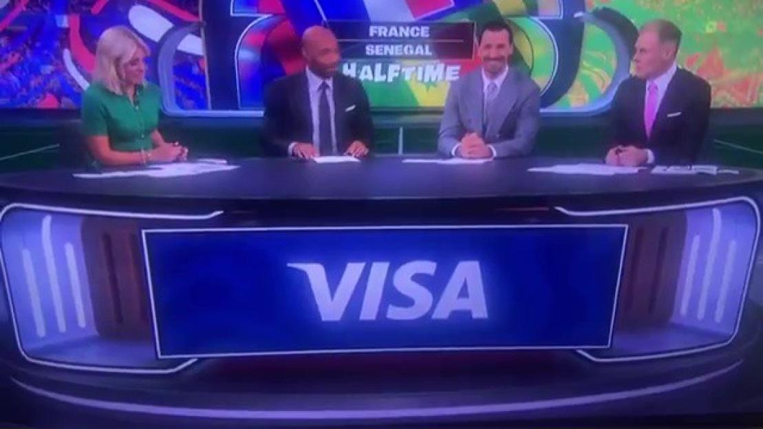 Four sports commentators sit behind a desk with a "VISA" logo on the front.
