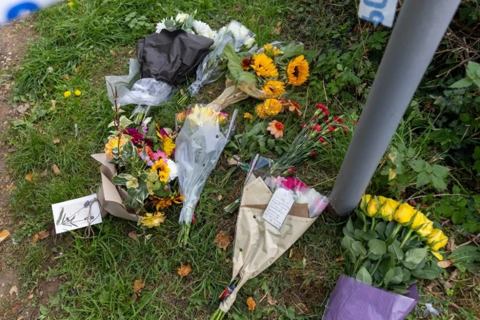 Floral tributes left at the scene where a GP was found murdered in Dersingham, Norfolk.
